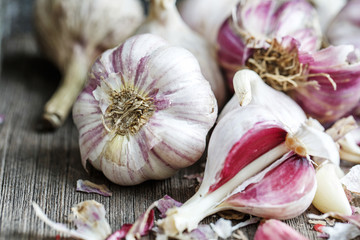 Garlic scattered on a wooden table. Garlic close-up