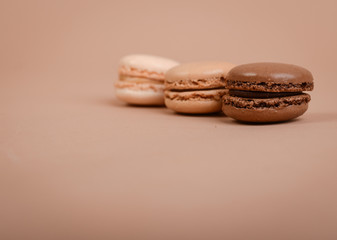 Deliious juicy makaroner, on beige color cappuccino background.