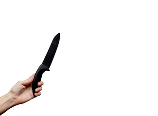 Female hands holding a big black kitchen knife. Food Concept. European, white background