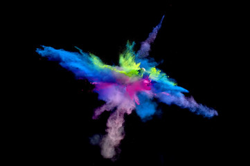 Multi Colored forms of powder paint and flour combined  together explode in front of a black background to give off fantastic  multi colored explosions.