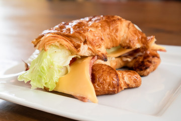 Cheese hams croissant served on the table.