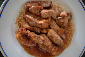 Stir fry pork on white dish for Thai porridge rice breakfast.