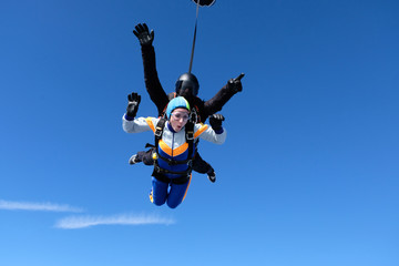 Fototapeta na wymiar Skydiving. Tandem jump for emotional pretty girl.