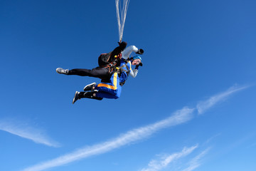 Obraz na płótnie Canvas Skydiving. Tandem jump for emotional pretty girl.