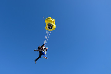 Skydiving. Tandem jump for emotional pretty girl.