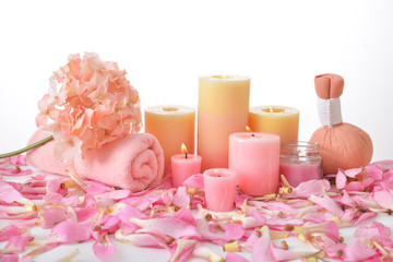 Many pink tropical petals background with five candle ,and rolled towel, herbal ball, Pink hydrangea