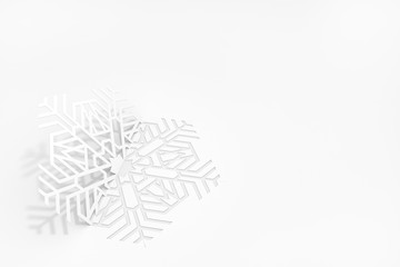 New year's eve greeting card concept. Snowflake cut from paper, casting a shadow. 3d illustration