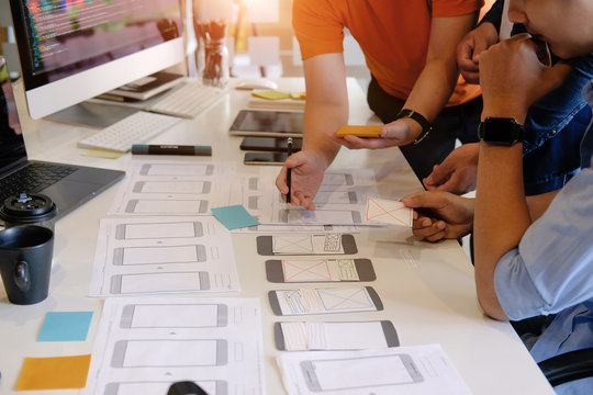 Programer Team working development software with UX UI project in computer and paper project with system analysis job.