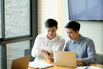 Fototapeta premium Business partner, A man working with laptop computer and digital table.