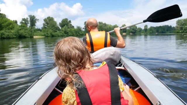father and daughter canoe on a calm river. Family fun and active sport. Slow Motion