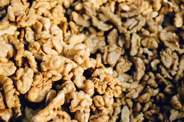 Top view of big shelled walnuts pile in farm market