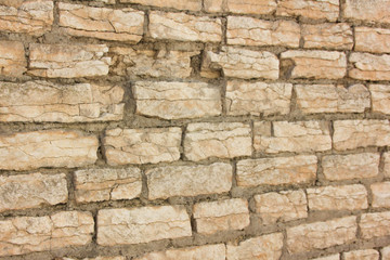 Old wall of rubble masonry. Rubble stone. Part of the ancient wall, fortress.