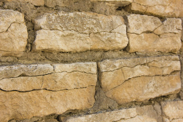 Old wall of rubble masonry. Rubble stone. Part of the ancient wall, fortress.