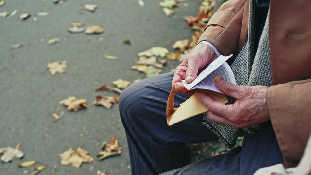 Crop senior man giving letter to wife