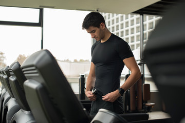 Fototapeta na wymiar young man preparing to run on treadmill