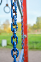 Close-up of large corroided domestic chain. Rusty blue painted metal chain