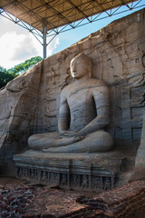 The stone image of Buddha Gautama in dhyana mudra, located in Gal Vihara of the area in the neighborhood of the ancient capital of Sri Lanka - the city of Polonnaruwa.