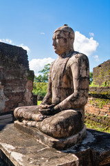 The old statue of Buddha in front of stupa, located on a temple Vatadage altar in ancient capital Polonnaruwa.
