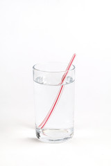 Plastic straw in glass of water