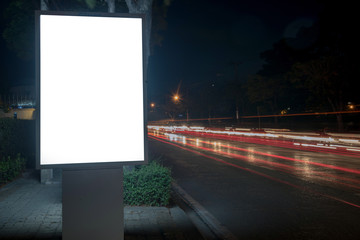 Blank Billboard on City Street at Night