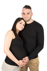 Happy pregnant woman in love with man husband in studio on white wall