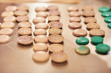 Fototapeta na wymiar macaroons shells in a tray. Process of making macaron, french dessert,