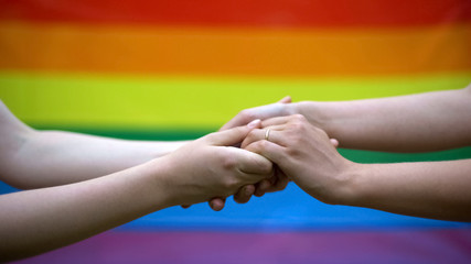 Gay wedding, rainbow flag on background, same-sex marriage, minority rights