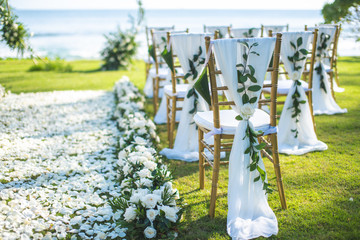 Chair decorated with flowers in Wedding ceremony.