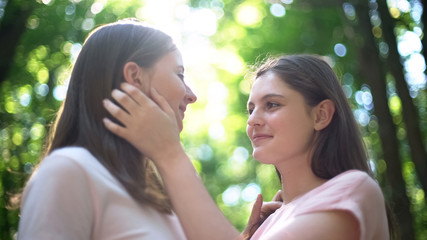 Attractive lesbian couple meeting secretly, love despite society condemnation