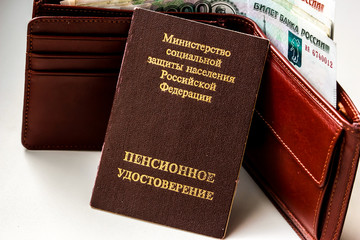 Russian pension certificate and wallet with russian rubles. Russian translation - Ministry of Social Protection of Population of Russian Federation. Pension Certificate.