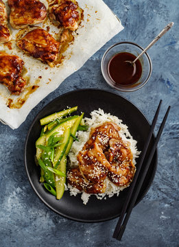 Hoisin Chicken. Traditional Asian cuisine. Chicken with sauce, rice and pickled cucumbers.