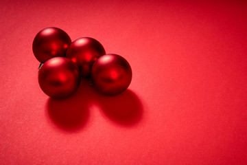 beautiful Christmas red baubles on a red background