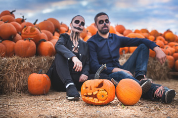Couple with scary makeup celebrating halloween outdoor