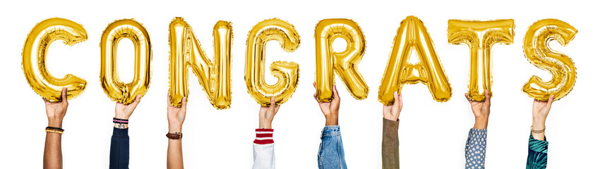 Yellow gold alphabet balloons forming the word congrats