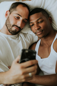 Couple taking a selfie in bed
