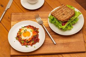 Coffee, sandwich and fried egg. Delicious breakfast