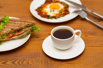 Coffee, sandwich and fried egg. Delicious breakfast