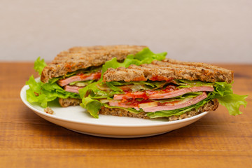 Ham, cheese, tomato and salad sandwich