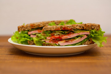 Ham, cheese, tomato and salad sandwich