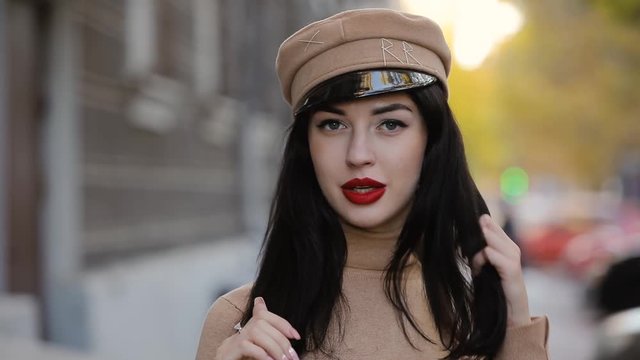 Sexy woman with red lips smiling in hat