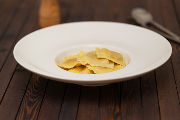 Plate of ravioli on dark background