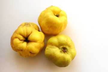 Ripe juicy yellow quince on a white background