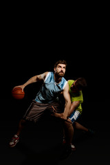 Basketball players isolated on black
