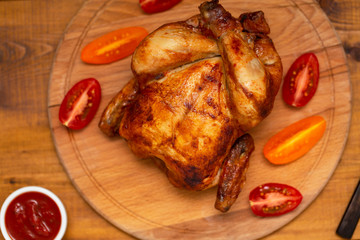 Roasted chicken on cutting board.