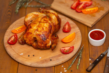 Roasted chicken on cutting board.