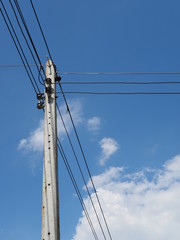 Electric power lines soaring into blue sky