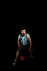 Fototapeta na wymiar Basketball player dribbling a ball