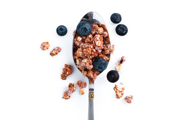 Photo of Full spoon of granola isolated on white background