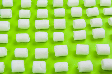 sweet marshmallow, candy on green background, top view