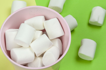 sweet marshmallow, candy on green background, top view